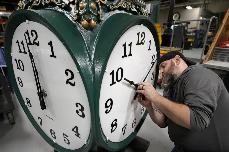 A wall clock showing an upcoming daylight saving time change